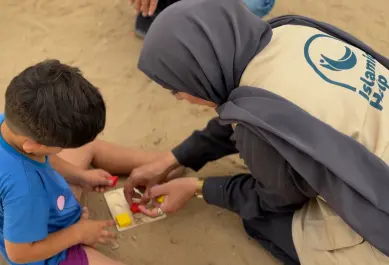 Child playing with IH Member