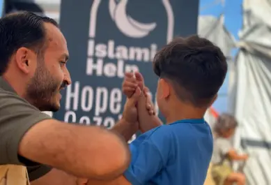 child with IH member – banner in background