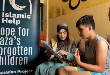 child with IH member – banner in background 2